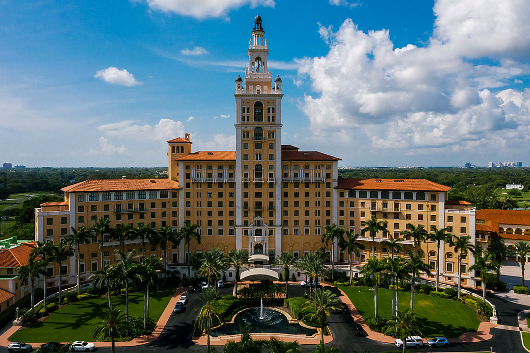 Aerial view of the Boca Raton Resort tower surrounded by palms