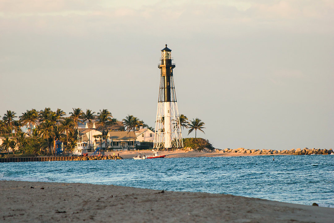 Lighthouse seen across the sand on a South Florida beach